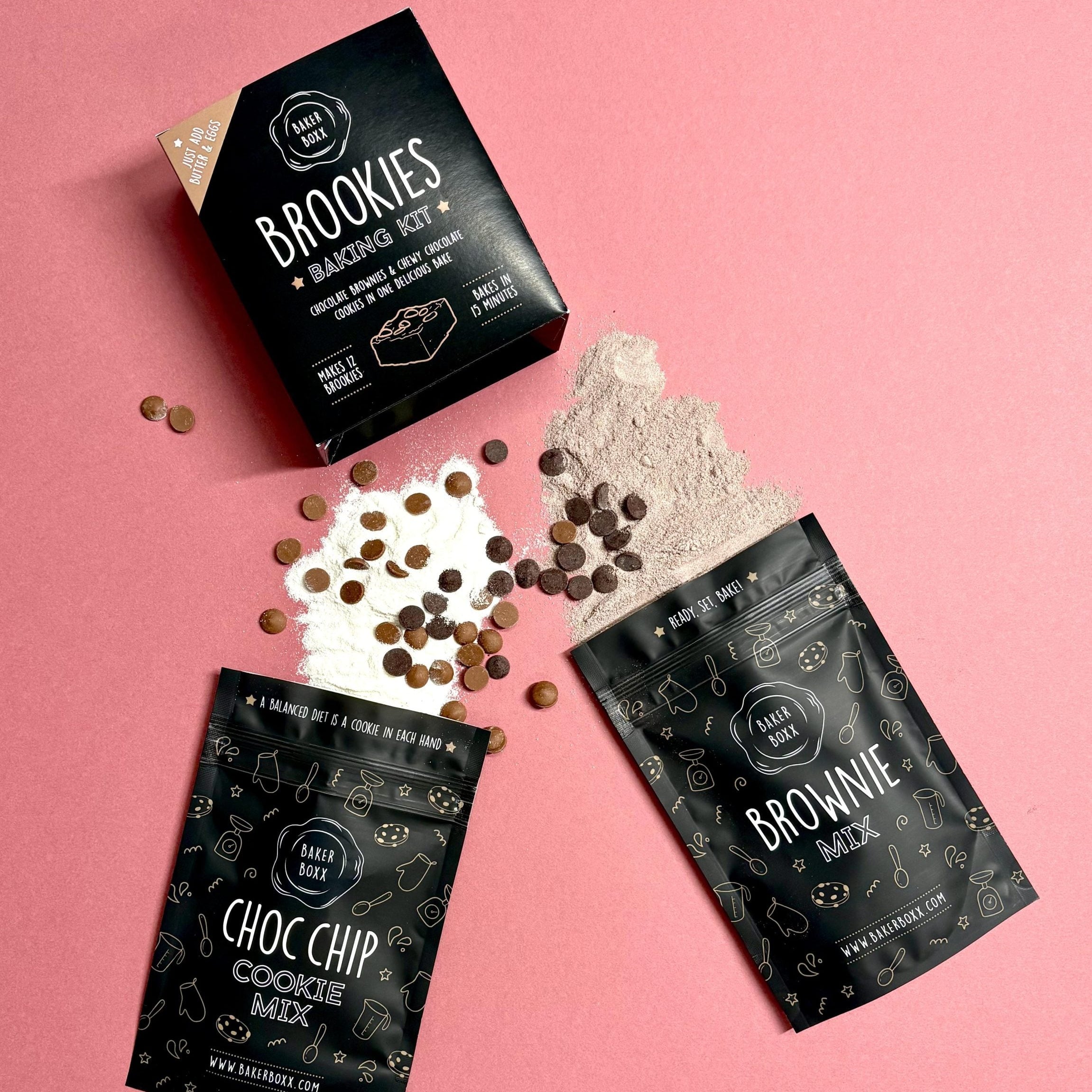 Baking mix packages with chocolate chips and baking powder on a pink background